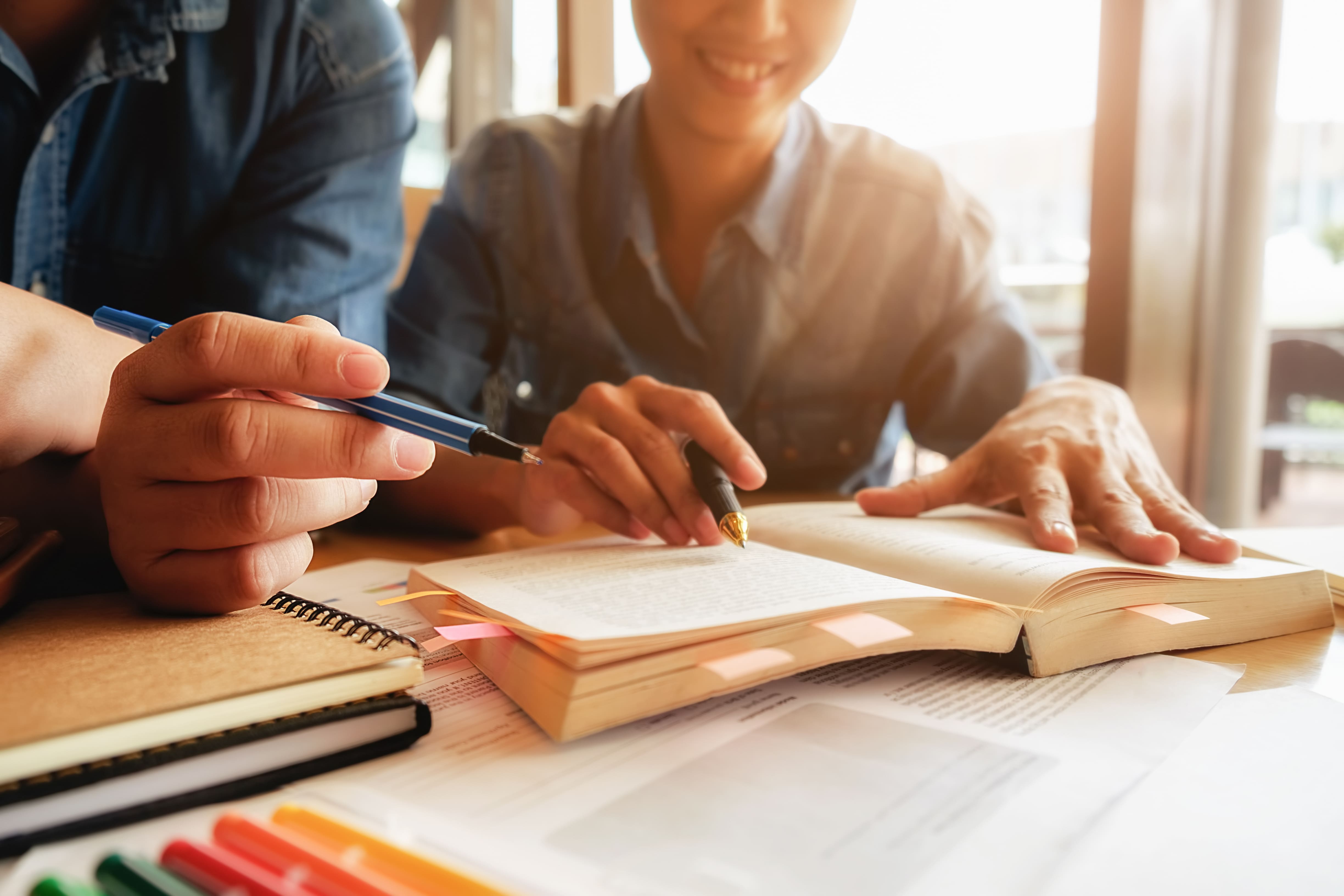 education-concept-student-studying-brainstorming-campus-concept-close-up-students-discussing-their-subject-books-textbooks-selective-focus (1).jpg